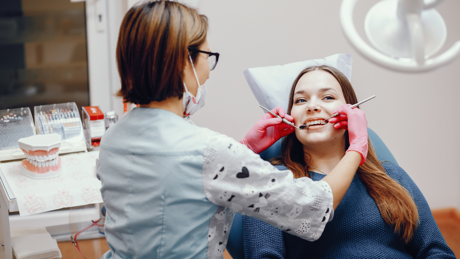 A modern Turkish dental clinic with a smiling, gender-neutral patient in their 30s sitting in a dental chair