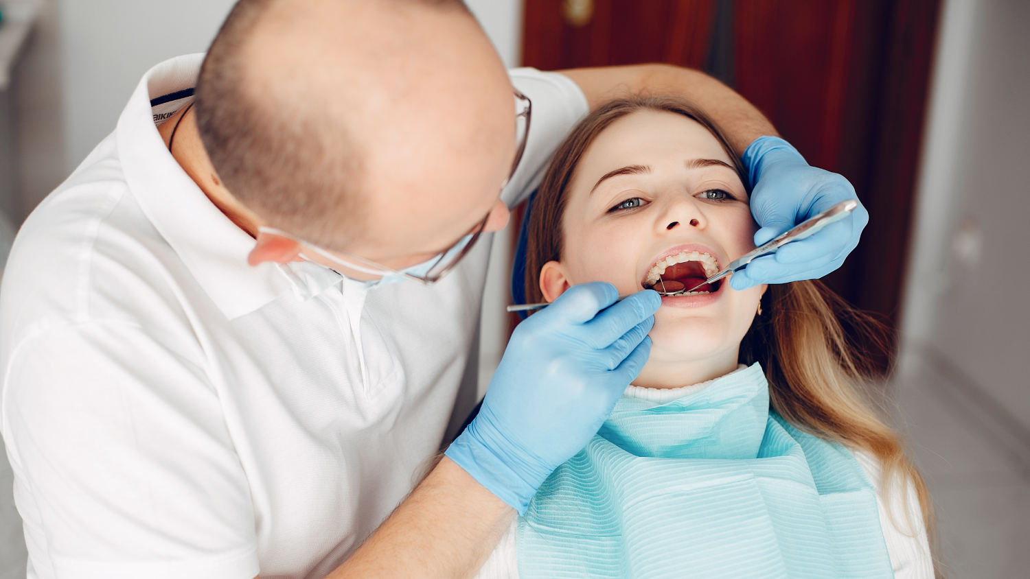 A modern Turkish dental clinic: a calm young adult patient sits in a dental chair